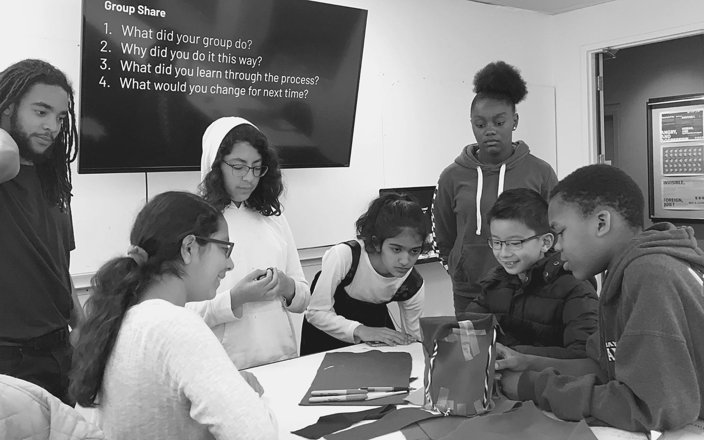 Students sharing their work as mentors observe